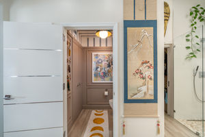 Hallway with striped ceiling, hanging scroll painting, and mustard patterned runner rug, designed for a bold Miami interior