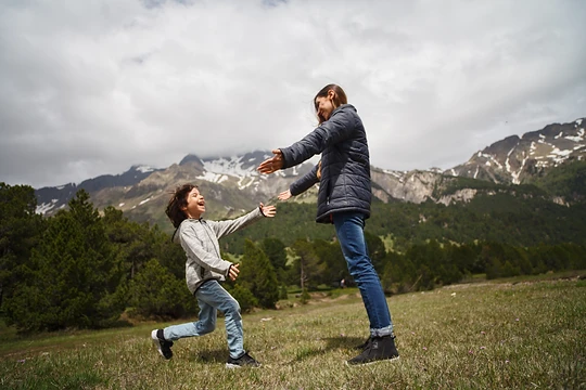 a child running to hug his mother