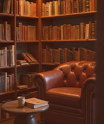 Image of a small library alcove with a comfortable leather easy chair
