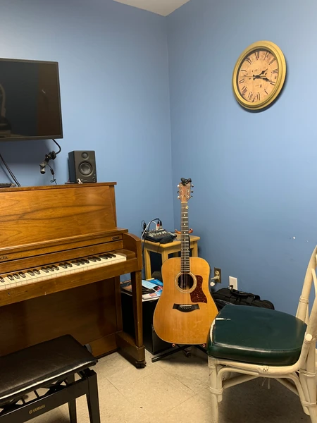 This is the studio of Christian Pawola Music. This is where I will be for online Zoom lessons. Lessons are conducted at Concert Musical Supply in Murfreesboro. tuned Baldwin piano, 30 year old Taylor acoustic guitar, creative vibe
