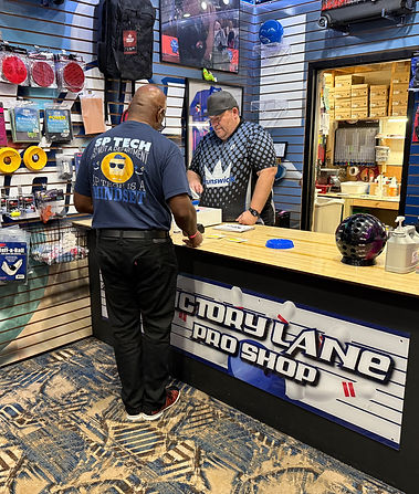 tim-mack-victory-lane-pro-shop-royal-pin-woodland-staff-interacting-with-customer