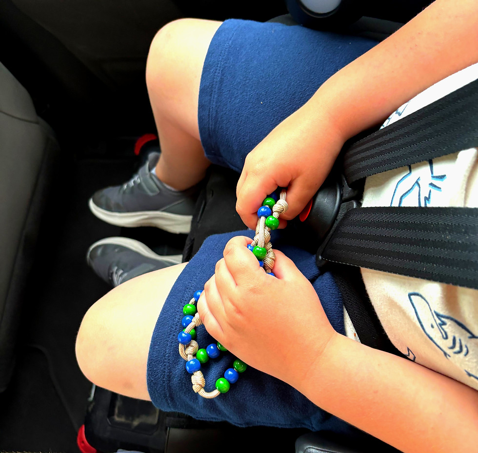 Child holding a Catholic rosary