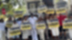 Dr Isaac L Williams and his team holding yard signs to support the campagin