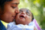 mom kissing a baby