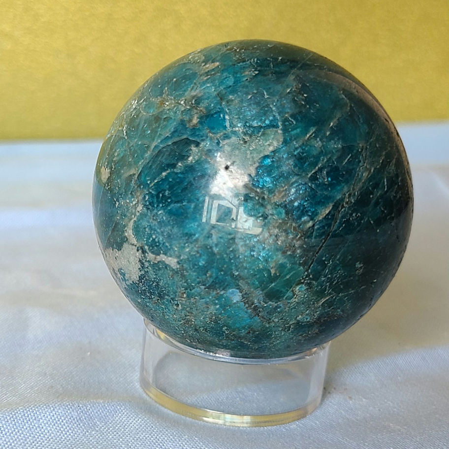Striated sphere with shiny green/blue accents
