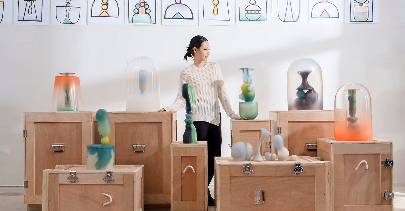 Visiting Artist Jinya Zhao in front of her glass pieces