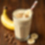 protein scoop peanut butter banana smoothie in a glass no background.jpg