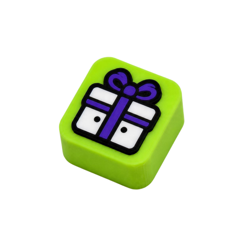 Lime green 3D-printed keycap with a smiling gift box icon, for the Create step