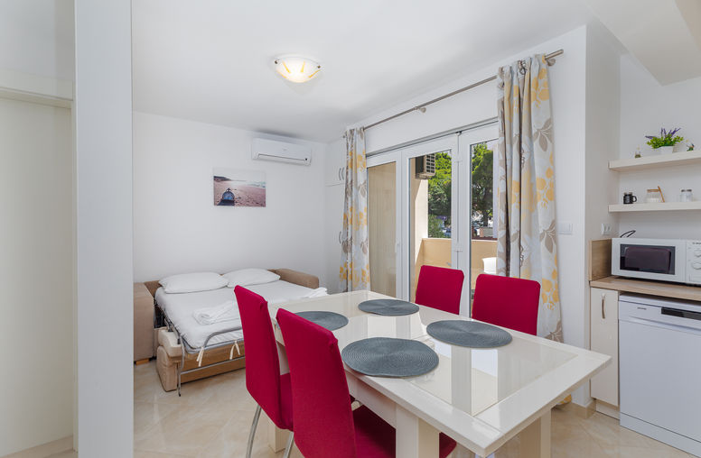 Living room with morning light and balcony view in Apartment 3 on the Omiš Riviera.