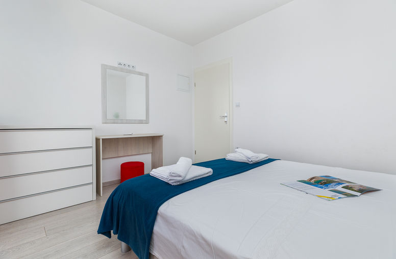 Bedroom with double bed, wall mirror and desk in Apartment 2 at Apartments Bosiljka, Medići.