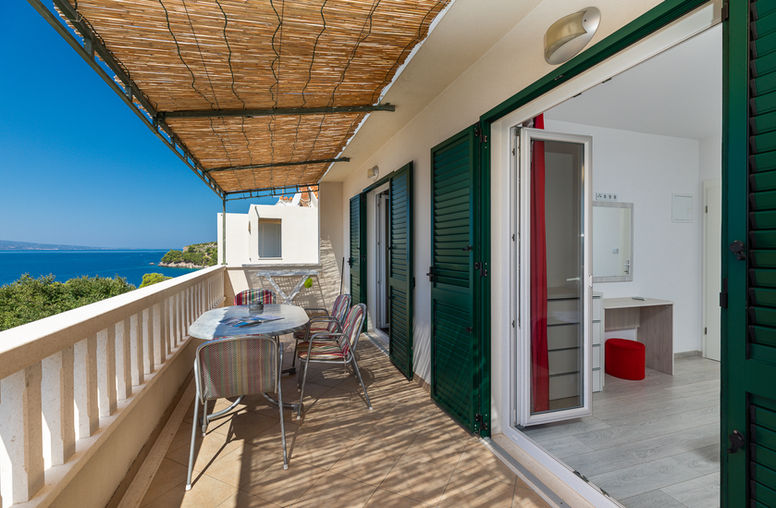 Balcony with Adriatic Sea view and visible room interior in Apartment 2 at Apartments Bosiljka, Medići.
