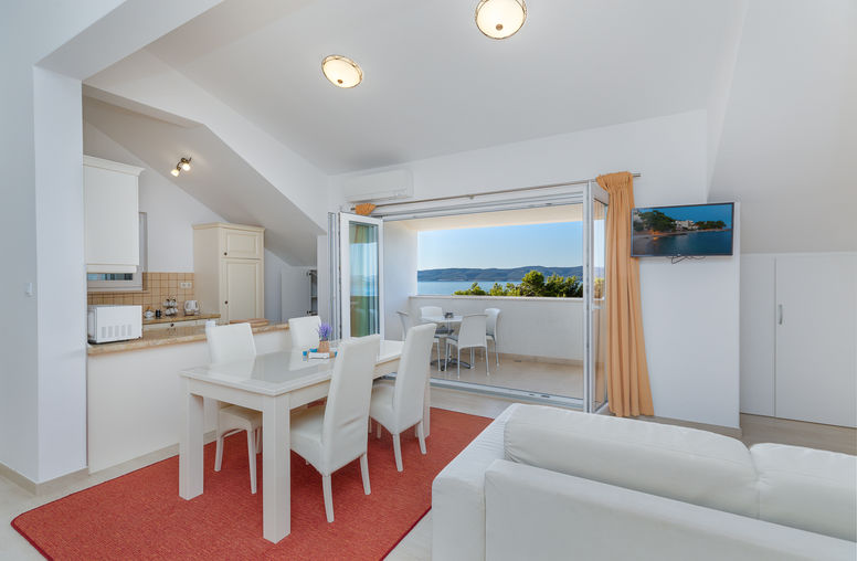Kitchen and dining area connected to the balcony with a direct sea view in Apartment 4 at Apartments Bosiljka, Medići.