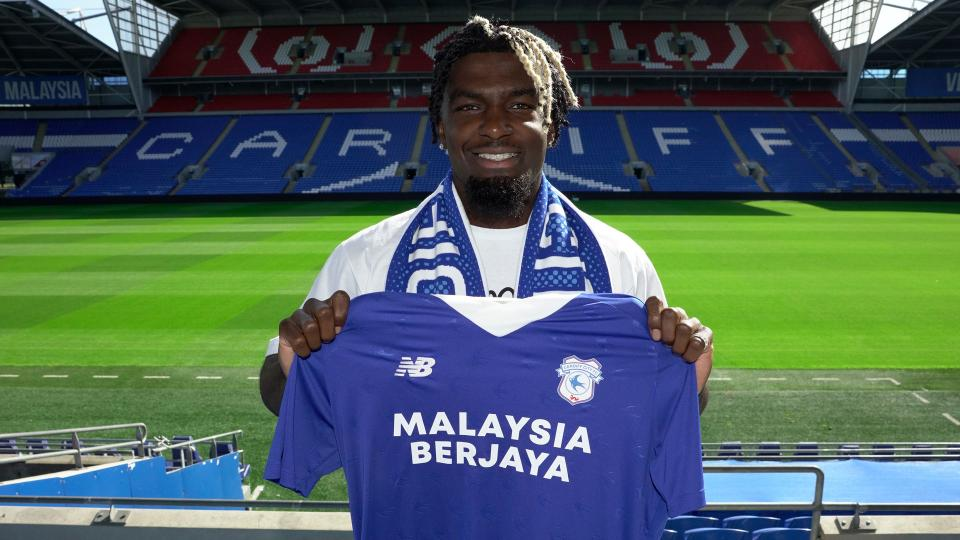 Cedric Kipre holding Cardiff shirt.