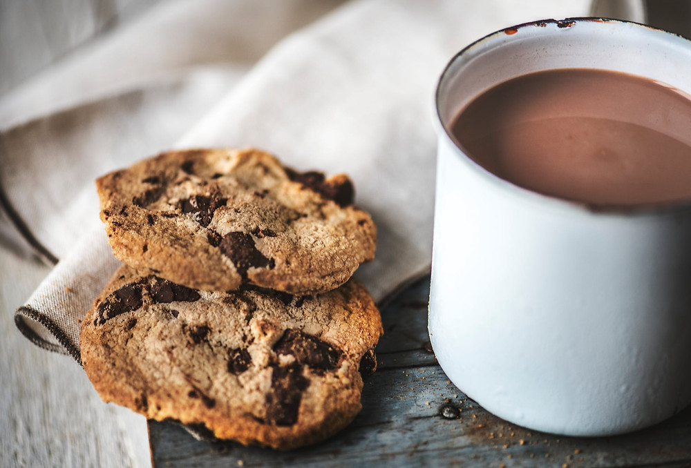 Cozy mug of hot cocoa and cookies feels like hygge