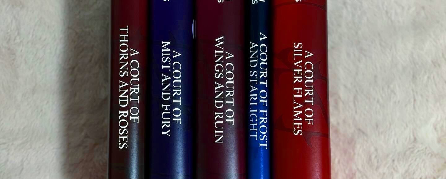 Sarah J. Maas ACOTAR book covers lined up on a shelf