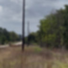 Acreage lot for sale in Bastrop County with electric poles on some lots