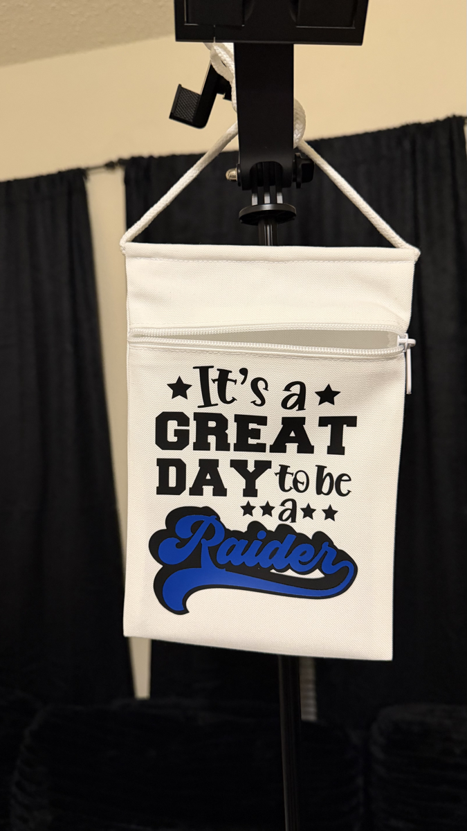 Custom order — a white canvas zipper pouch reading “It's a Great Day to be a Raider”