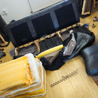 Internal wooden frame sofa webbing and springs during professional repair
