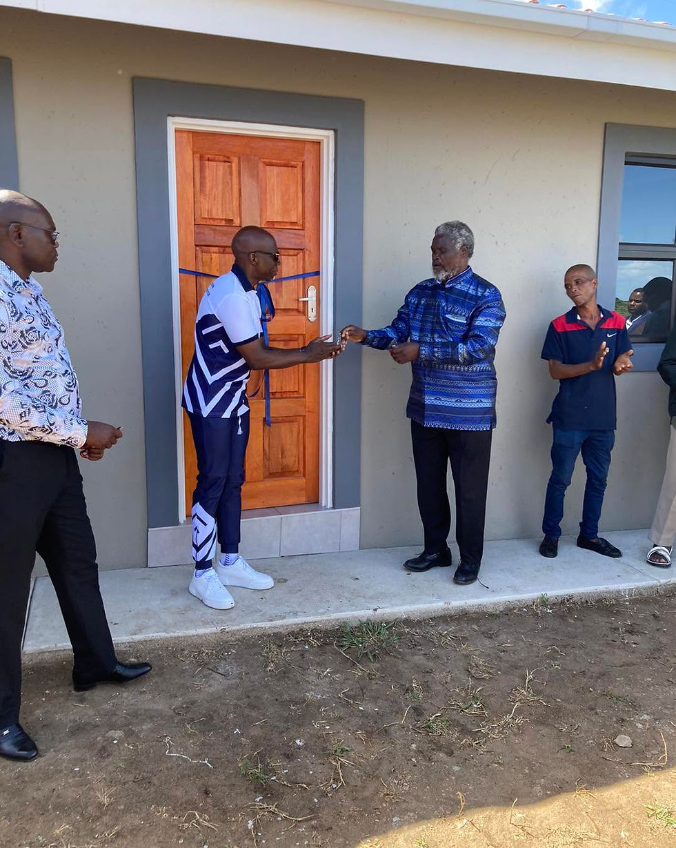 Entsika Foundation Chairman Zakhele Mkhize on giving a new homeowner the keys to his new home which was built by the foundation. Photo Credit: Entsika Foundation.
