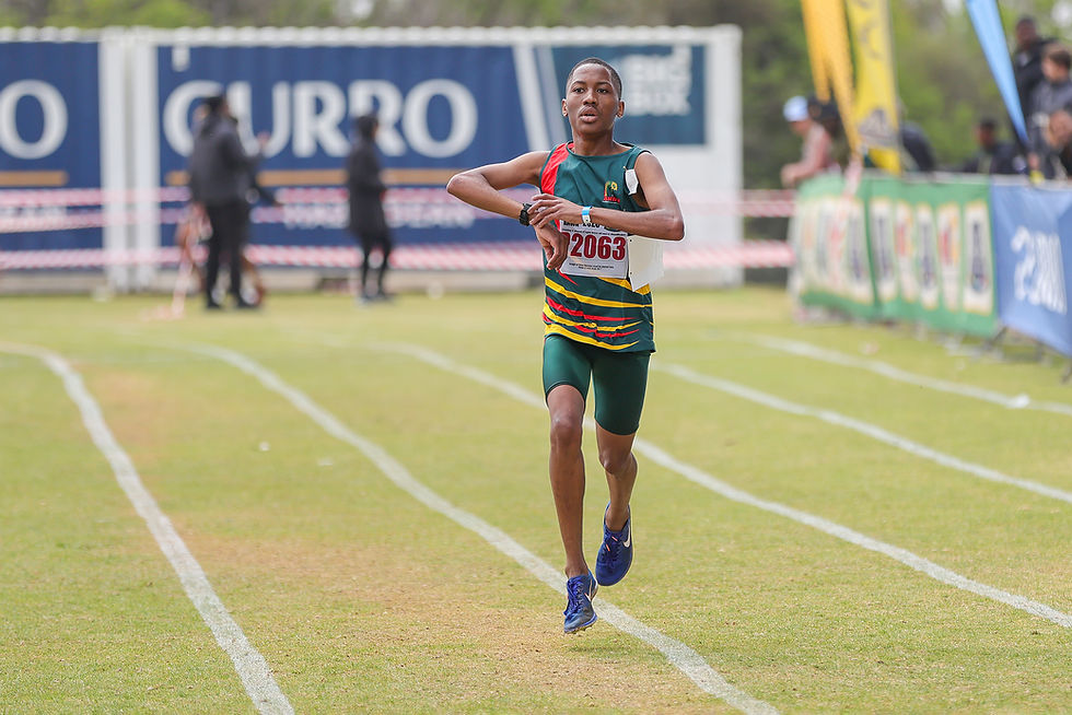 Molopi stops his watch as he crosses the finish line to claim a memorable bronze medal. Photo Credit: Cecilia van Bers.
