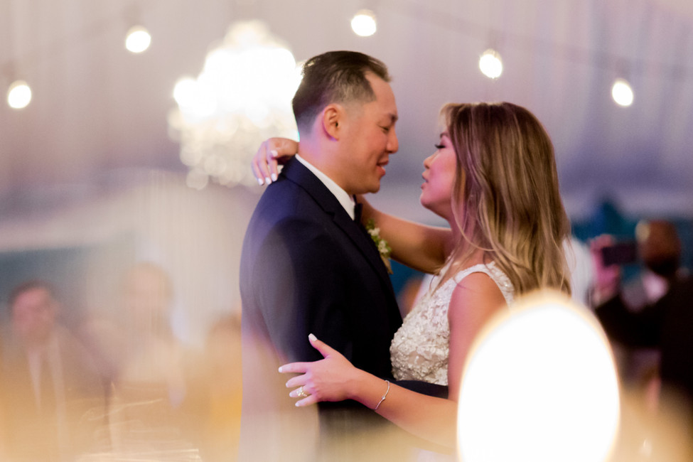 Romantic first dance for bride and groom with warm spotlighting and custom wedding production in NJ.