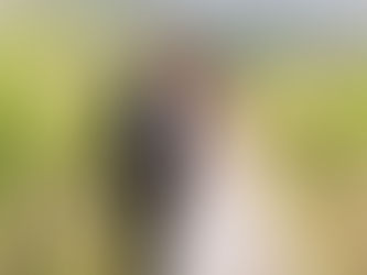Bruidspaar loopt tijdens golden hour door de wijngaarden van Toscane en kijkt elkaar liefdevol aan tijdens hun bruiloftsshoot in Italië