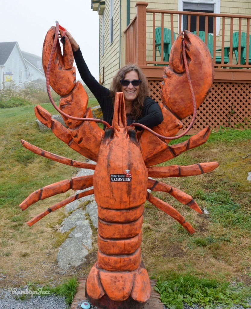 The author posing behind a tall lobster sculpture