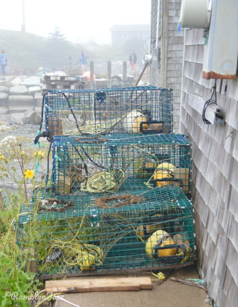 lobster traps stacked against a shingled wall