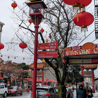Street scene showing lanterns, stylized script, and a lamp standard