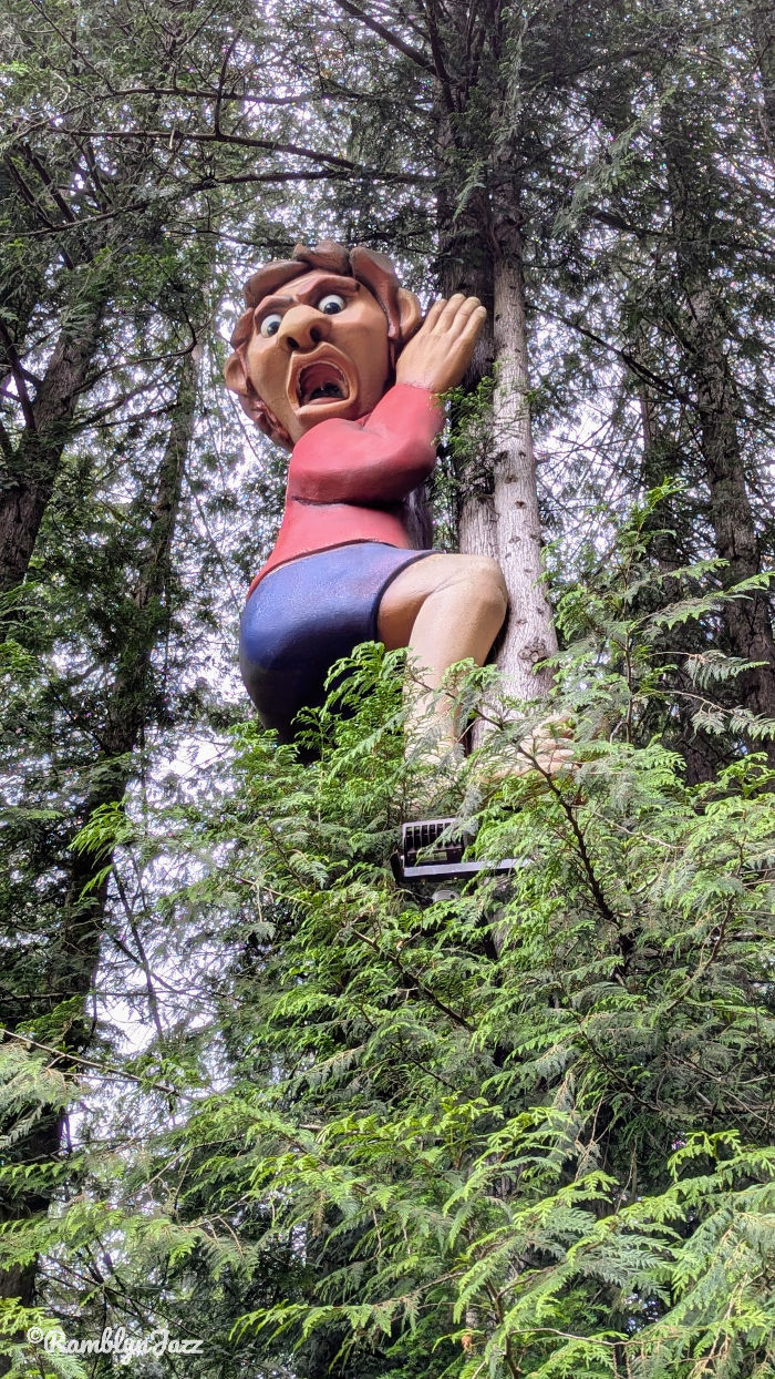 A large giant character climbing down a tree