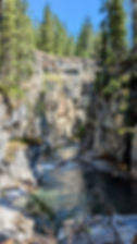 A slot canyon with a river running through