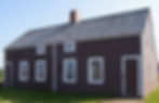 Exterior of a wooden duplex style house painted brown with white trim