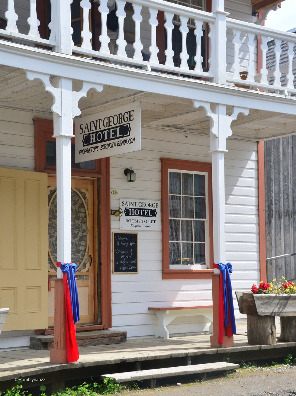 Entrance to a mid 1800s style hotel with an upper balcony
