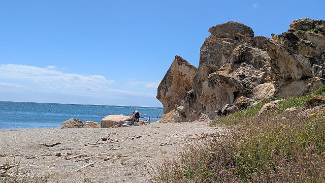 jagged tall rocks on the edge of a beach