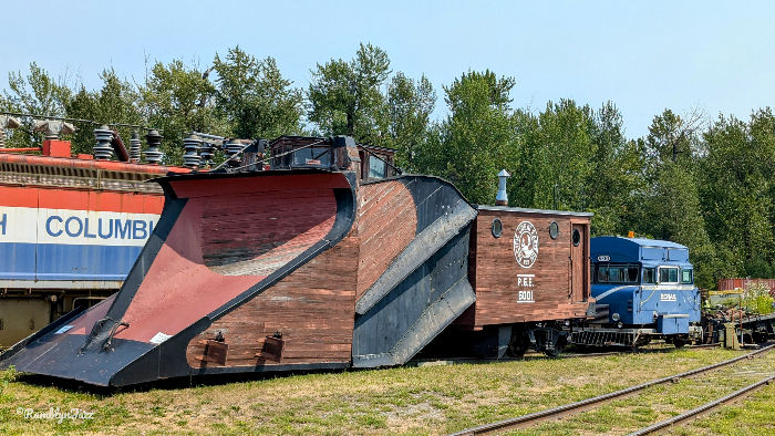 A huge snowplow attached that would be attached to the front of an engine