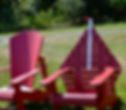 2 wooden outdoor chairs painted red