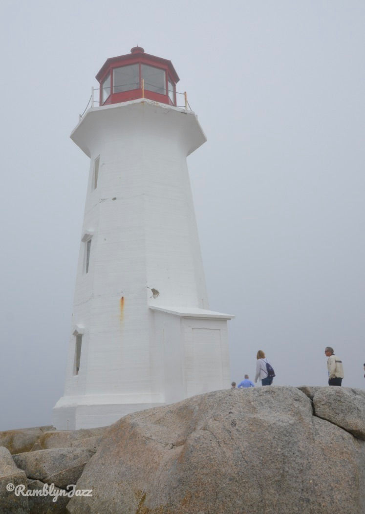 looking up at the Peggy's Cove Lighthouse on a foggy day