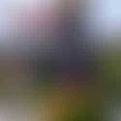 a black totem pole with thunderbird at top