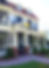 The exterior of a grand Victorian house with a wraparound patio