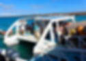 Eye-level view of a small boat docked at a Galapagos island pier