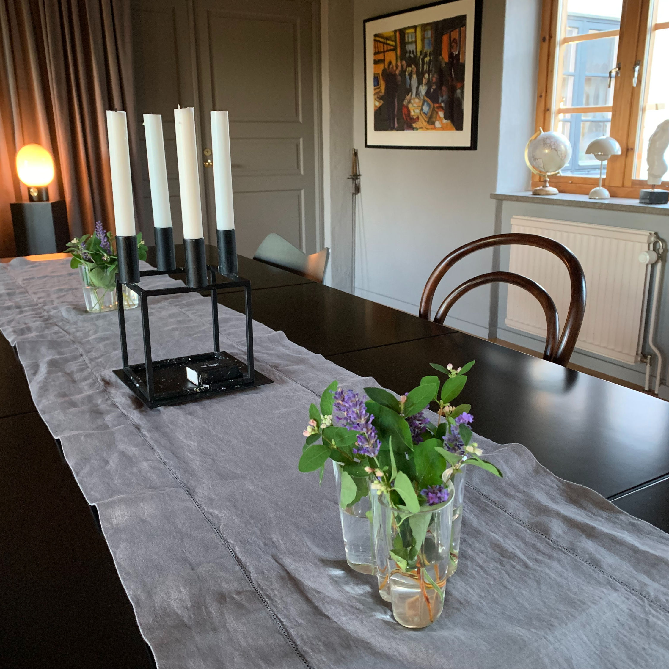 Mellby Atelier French organic linen table runner with dotted hemstitch in charcoal, displayed on a large dining table.