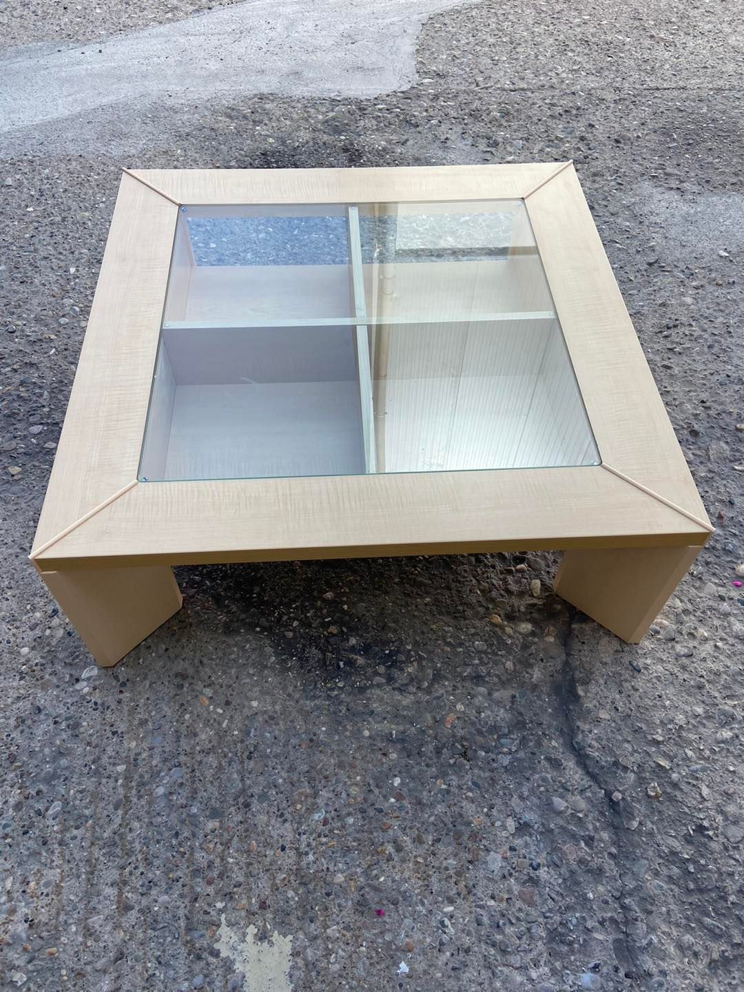 Pale wood veneer coffee table with sectional storage under glass 