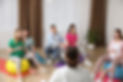 Pregnant women with men and doctor at courses for expectant parents indoors.jpg