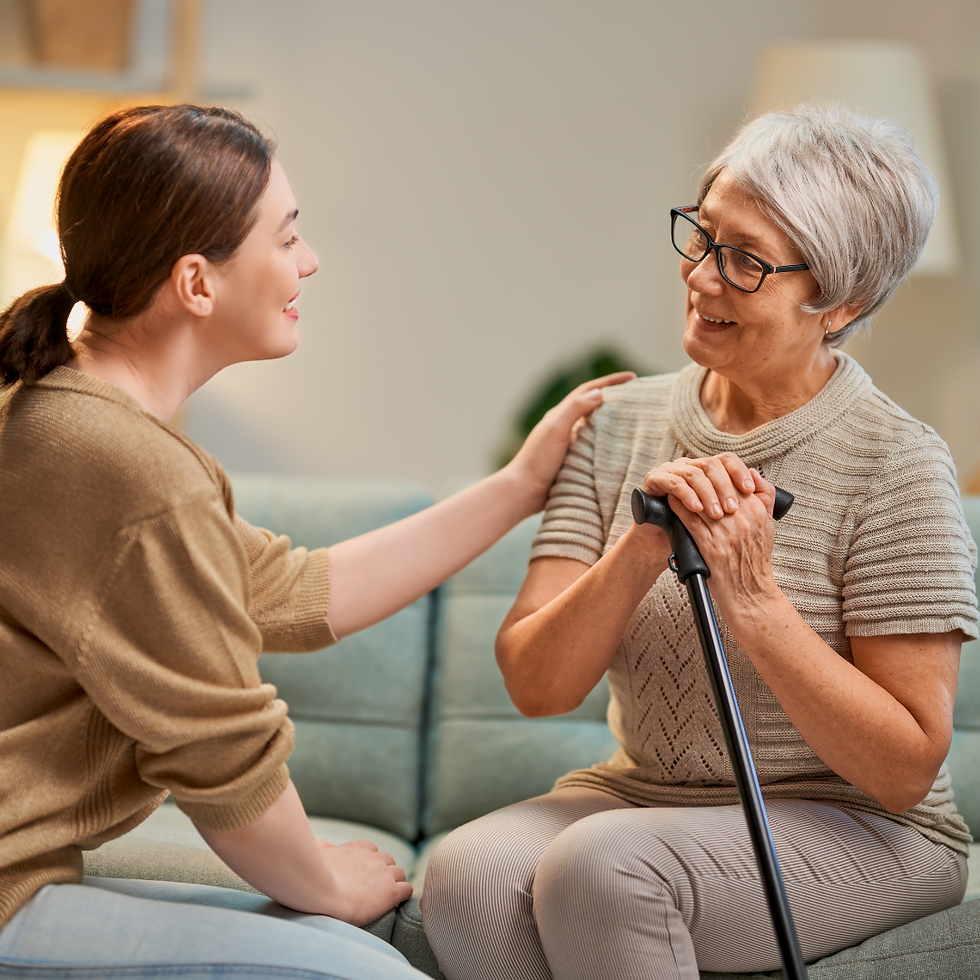 caregiver gently speaking with an elderly person, both smiling warmly.