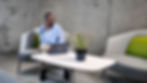 Professional commercial photography of man on phone at laptop