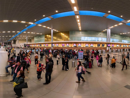 Bogota airport arrivals area with travelers and security at El Dorado International Airport