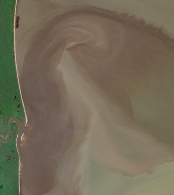 A satellite image of muddy water in the ocean from a river