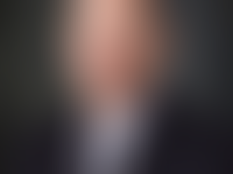 Professional business headshot of a confident executive in a suit, captured by a headshot photographer near me with studio lighting and a clean, neutral background.