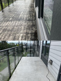 Before and after balcony cleaning, showing a balcony covered with algae, moss, dirt, and grime at the top and the cleaned balcony at the bottom.