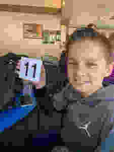 Boy holding restaurant sign 11
